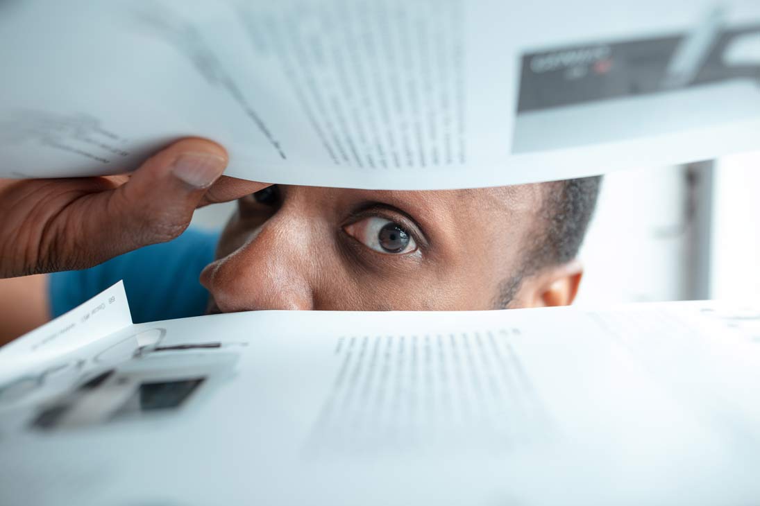 African-American man looking for paperwork in postage box